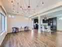 Open concept living area features modern lighting and flows into a sleek, modern kitchen at 5188 Andes Way, Denver, CO 80249