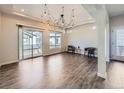 Spacious living room features hardwood floors, large windows, and stylish modern lighting at 5188 Andes Way, Denver, CO 80249