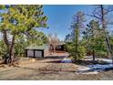 A cozy home exterior with two car garage among the trees at 11540 Inspiration Rd, Golden, CO 80403
