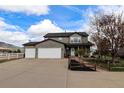 Spacious home with a three-car garage, concrete driveway, and beautiful landscaping in a rural setting at 3530 Doolittle Rd, Monument, CO 80132