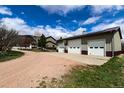 View of a large, detached garage with multiple bays and solar panels on the roof at 3530 Doolittle Rd, Monument, CO 80132