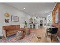 Bright open-concept living room with hardwood floors and modern kitchen access, ideal for entertaining at 3003 California St, Denver, CO 80205