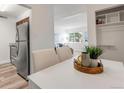 Bright dining area with white table and kitchen access at 3613 S Sheridan Blvd # 11, Denver, CO 80235