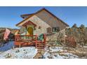 Quaint stucco home with a red deck and colorful accents at 347 Buena Vista, Palmer Lake, CO 80133