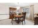 Dining room featuring a wooden table, chairs, a hutch, and a chandelier at 3680 S Pontiac Way, Denver, CO 80237