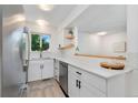 Updated kitchen with white cabinets, stainless steel appliances, and stylish backsplash at 9255 E Lehigh Ave # 208, Denver, CO 80237