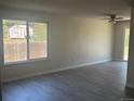 Bright living room featuring new wood floors, fresh paint, a ceiling fan, and lots of natural light at 8491 W Star Cir, Littleton, CO 80128