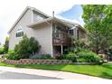 Lovely home with a charming porch, beautiful landscaping, and brick accents, set against a clear blue sky at 1470 S Quebec Way # 245, Denver, CO 80231