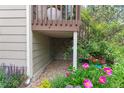 Image shows under-deck area surrounded by a garden featuring a variety of colorful flowers and plants at 1470 S Quebec Way # 245, Denver, CO 80231