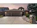 Charming two-story home featuring a brick facade, three-car garage, and well-maintained landscaping at 1123 Oakhurst Dr, Broomfield, CO 80020