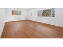 Spacious living room displaying gleaming hardwood floors and a large window for ample light at 5730 E 19Th Ave, Denver, CO 80220