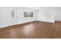 Bright living room featuring hardwood flooring and natural light from large windows at 5730 E 19Th Ave, Denver, CO 80220