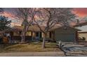 Inviting single-story home with a classic brick and siding facade and a well-manicured front lawn at 3387 S Pitkin Way, Aurora, CO 80013