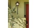 Inviting front door with a smart doorbell, decorative light fixture, and clear house number at 3209 Redstone Rd # 12B, Boulder, CO 80305