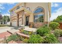 Stunning home exterior showcasing stone accents, mature landscaping, and a welcoming front porch, creating an inviting curb appeal at 4520 Maroon Cir, Broomfield, CO 80023