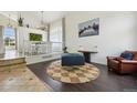 Bright living area featuring modern decor, stylish furniture, and an open view to the dining area, creating an inviting space at 4520 Maroon Cir, Broomfield, CO 80023