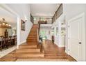 Elegant two-story foyer features hardwood floors, staircase, and views of the dining and living rooms at 3502 Birch Ave, Parker, CO 80134