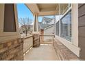A charming front porch featuring brick columns and a view of the neighborhood at 5531 Fox Meadow Ave, Highlands Ranch, CO 80130