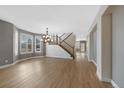 Spacious living room featuring hardwood floors, large windows, and a modern chandelier at 5531 Fox Meadow Ave, Highlands Ranch, CO 80130