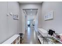 Bright hallway featuring hardwood floors, neutral paint and decor with shoe storage at 10344 Vienna St, Parker, CO 80134