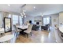 Open concept living room with modern lighting, fireplace, and hardwood floors at 10344 Vienna St, Parker, CO 80134