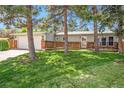 Inviting single-story home featuring a covered front porch and a lush, green front lawn at 7773 Brentwood Ct, Arvada, CO 80005