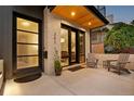 Inviting front porch features brick accents, stylish seating, and a view into the well-lit dining area at 257 Jackson St, Denver, CO 80206