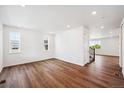 Spacious living room with hardwood floors, three windows, and recessed lighting throughout the room at 5614 Riverbend Ave, Firestone, CO 80504