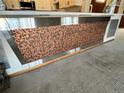 Unique kitchen island with a penny-covered facade at 775 S Alton Way # 3D, Denver, CO 80247