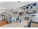 Open-concept kitchen and dining area with stainless appliances and views of the living area at 11870 Cattle Ln, Parker, CO 80134