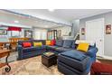 Comfortable living room with sectional sofa, stylish decor, and adjacent dining area at 4967 S Urban Ct, Morrison, CO 80465