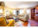 Cozy living room featuring plush seating, hardwood floors, and ample natural light at 9512 W Ontario Dr, Littleton, CO 80128