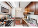 Functional kitchen featuring appliances, granite countertops, and overhead lighting at 2900 Shadow Creek Dr # 201, Boulder, CO 80303