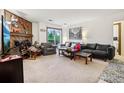 Spacious living room with balcony access, a decorative fireplace, and cozy seating arrangement at 2900 Shadow Creek Dr # 201, Boulder, CO 80303