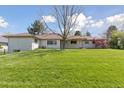 View of the backyard from the far corner of the property with mature landscaping at 3775 S Forest Way, Denver, CO 80237
