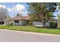 Beautiful single-story home with a well-kept lawn and mature landscaping at 3775 S Forest Way, Denver, CO 80237