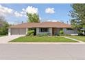 Charming single-story home featuring an attached two car garage and a beautifully maintained front lawn at 3775 S Forest Way, Denver, CO 80237