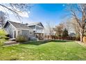 Large, well-maintained backyard with a lush lawn, two-level deck and privacy fence, ideal for outdoor activities at 9742 Burntwood Ct, Highlands Ranch, CO 80126