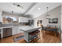 Open kitchen featuring an island with bar stool seating, and light wood floors at 9742 Burntwood Ct, Highlands Ranch, CO 80126