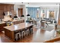 Open-concept living space featuring hardwood floors and a stylish kitchen and spacious seating area at 5470 Wabash St, Denver, CO 80238