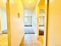 Hallway with tile and carpet flooring leading into the living room at 8826 E Florida Ave # 102, Denver, CO 80247