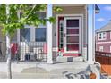 Charming front porch featuring a red door, railing, and space for outdoor seating at 1673 Morningview Ln, Castle Rock, CO 80109