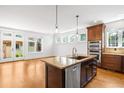 Modern kitchen with island, stainless steel appliances, and ample counter space at 1934 S Sherman St, Denver, CO 80210