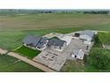 Overhead view of rural property featuring a home, garage, outbuildings, and spacious surroundings at 6331 County Road 32, Platteville, CO 80651