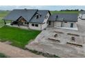 The expansive covered porch, dormer windows, and garden boxes add character to this exterior at 6331 County Road 32, Platteville, CO 80651