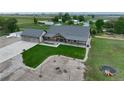 A beautiful exterior view shows a well-maintained yard and lovely stonework detail at 6331 County Road 32, Platteville, CO 80651