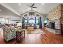 Open living room featuring a fireplace, high ceilings, and large windows with views at 6331 County Road 32, Platteville, CO 80651