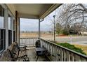 Relaxing front porch view of the neighborhood with seating and a small table at 12135 Elizabeth St, Thornton, CO 80241