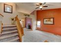 Spacious living room with carpet flooring, stairs, and a vaulted ceiling at 12135 Elizabeth St, Thornton, CO 80241