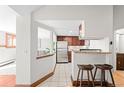 Bright kitchen featuring stainless steel appliances, breakfast bar, and easy access to living areas at 2351 Federal Blvd # 102, Denver, CO 80211